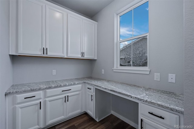 clothes washing area with dark wood-type flooring