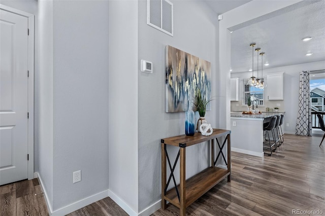 hallway with dark hardwood / wood-style flooring