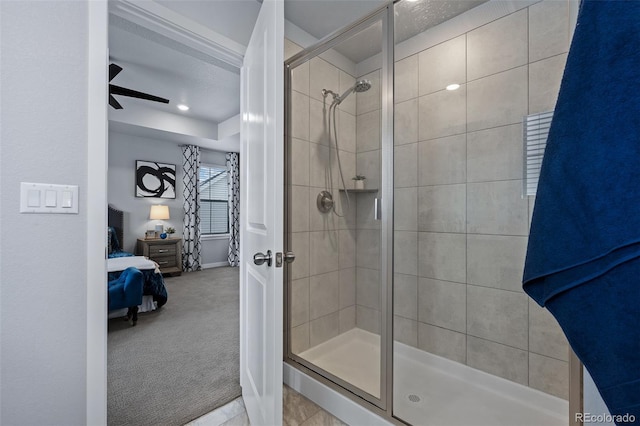 bathroom featuring ceiling fan and a shower with door