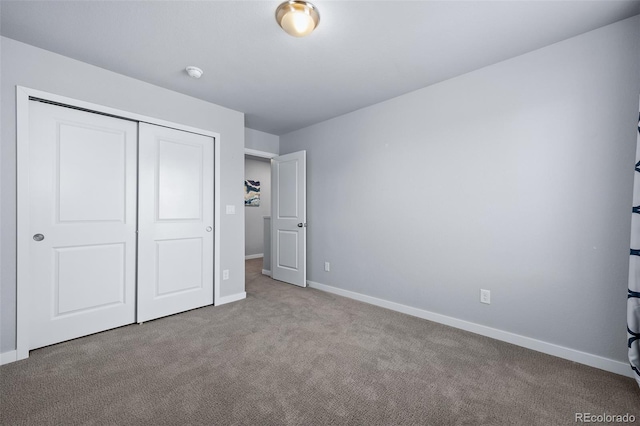 unfurnished bedroom with light carpet and a closet