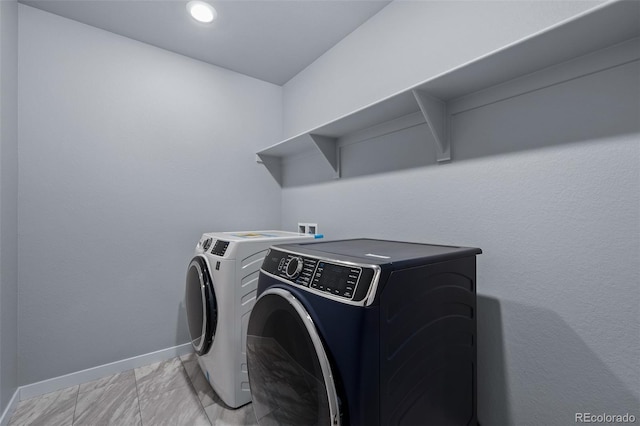 laundry area with recessed lighting, baseboards, washing machine and dryer, and laundry area