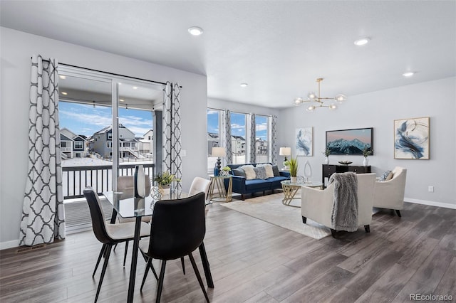 dining space featuring recessed lighting, baseboards, an inviting chandelier, and wood finished floors