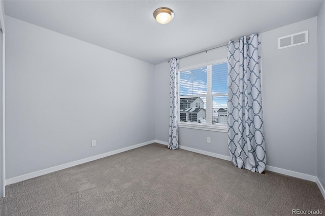 unfurnished room featuring carpet flooring, baseboards, and visible vents