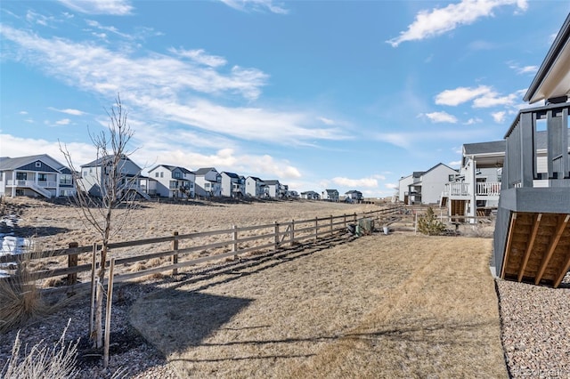 view of yard featuring fence and a residential view