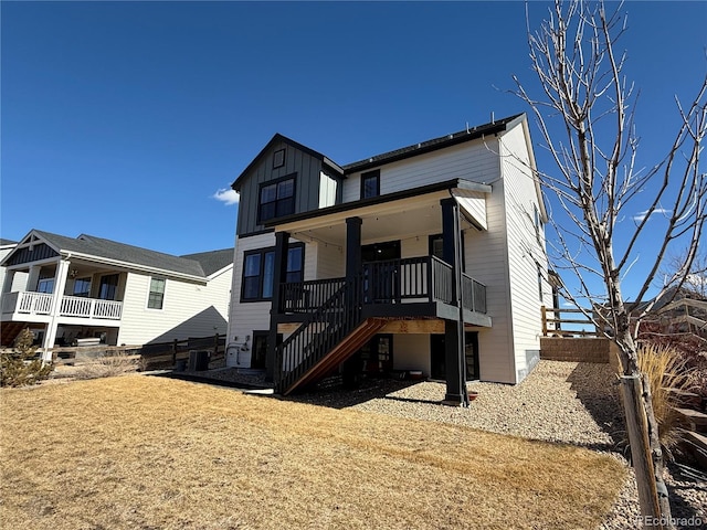 view of front of home with stairway, cooling unit, and board and batten siding