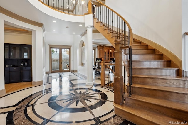 foyer with recessed lighting, french doors, a high ceiling, and baseboards