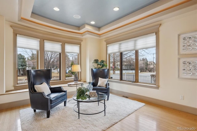 sitting room with plenty of natural light and hardwood / wood-style flooring