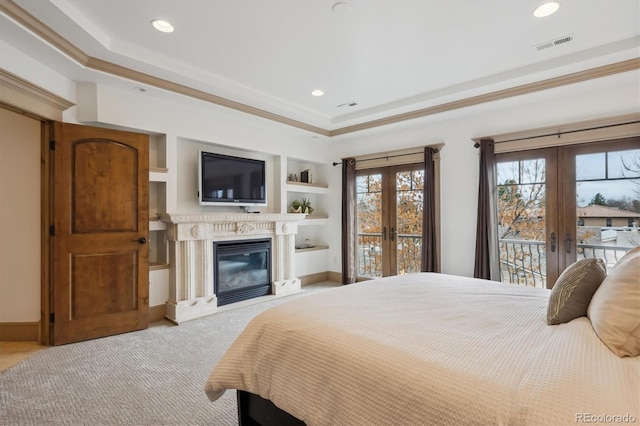 bedroom featuring access to outside, visible vents, a raised ceiling, and french doors