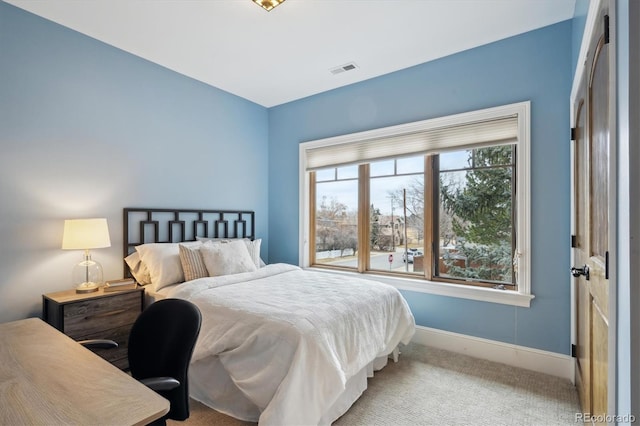 carpeted bedroom with baseboards and visible vents