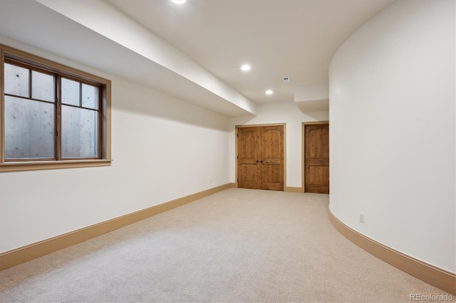 unfurnished room featuring recessed lighting, baseboards, and light colored carpet