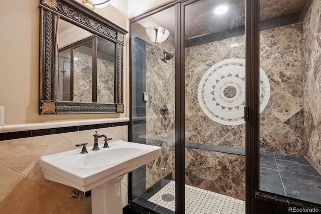 bathroom with tile walls and a shower stall