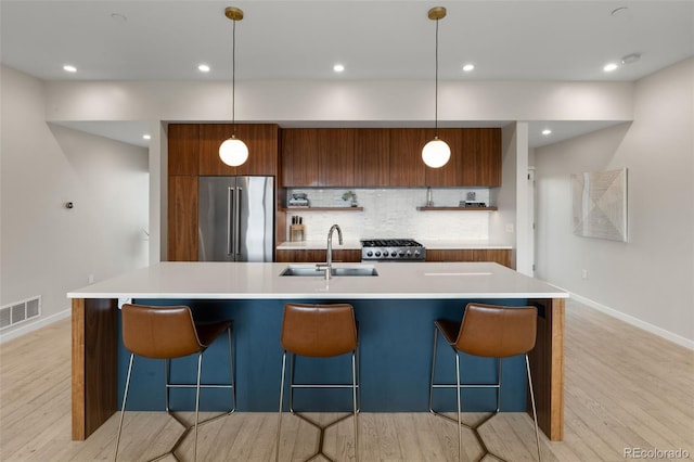 3233 Tejon St Unit 305, Denver, CO 80211 - kitchen with high quality fridge, modern cabinets, range, light wood-style floors, and recessed lighting