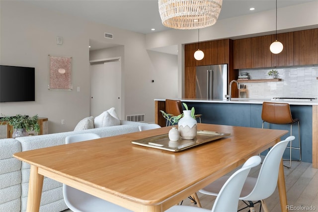 3233 Tejon St Unit 305, Denver, CO 80211 - dining area featuring light wood-type flooring, recessed lighting, and a chandelier