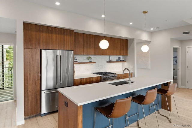 3233 Tejon St Unit 305, Denver, CO 80211 - kitchen with high end appliances, brown cabinets, modern cabinets, backsplash, and light countertops