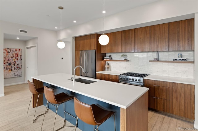 3233 Tejon St Unit 305, Denver, CO 80211 - kitchen with high quality appliances, modern cabinets, brown cabinetry, backsplash, and light wood-style flooring