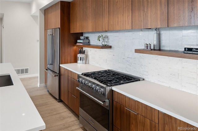 3233 Tejon St Unit 305, Denver, CO 80211 - kitchen featuring appliances with stainless steel finishes, modern cabinets, open shelves, and tasteful backsplash