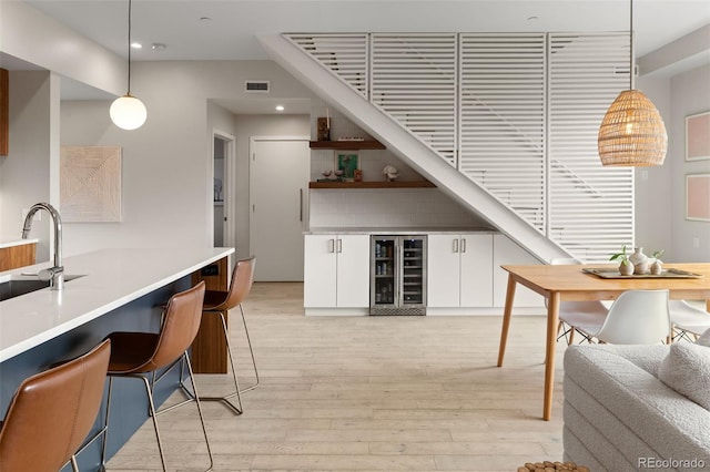 3233 Tejon St Unit 305, Denver, CO 80211 - indoor dry bar with beverage cooler, light wood-style floors, pendant lighting, and recessed lighting