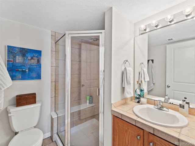 full bathroom with a stall shower, visible vents, vanity, and toilet