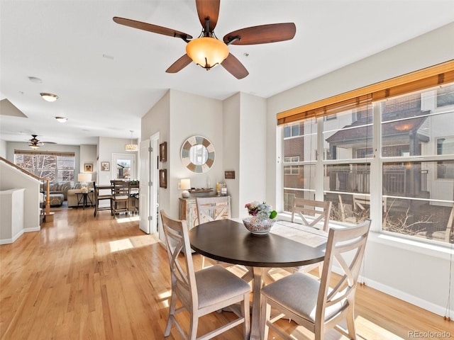 dining room featuring light wood-type flooring and baseboards