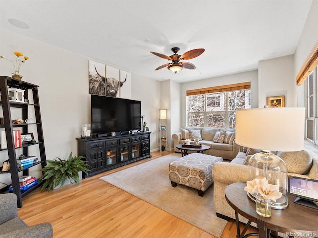 living area featuring wood finished floors and a ceiling fan