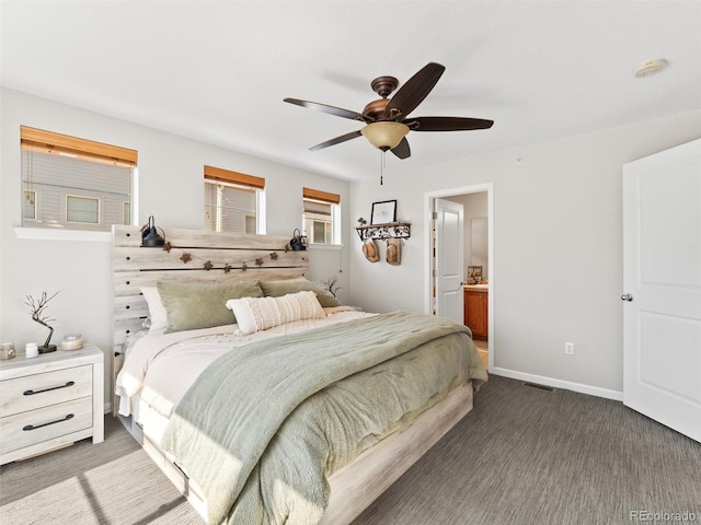 carpeted bedroom with ceiling fan, visible vents, baseboards, and connected bathroom