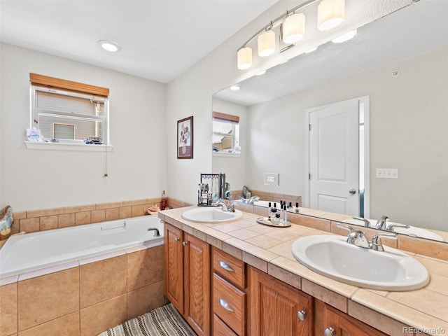 full bath with a garden tub, double vanity, and a sink