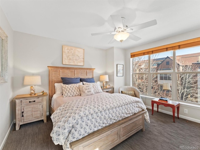 bedroom featuring ceiling fan, dark colored carpet, and baseboards