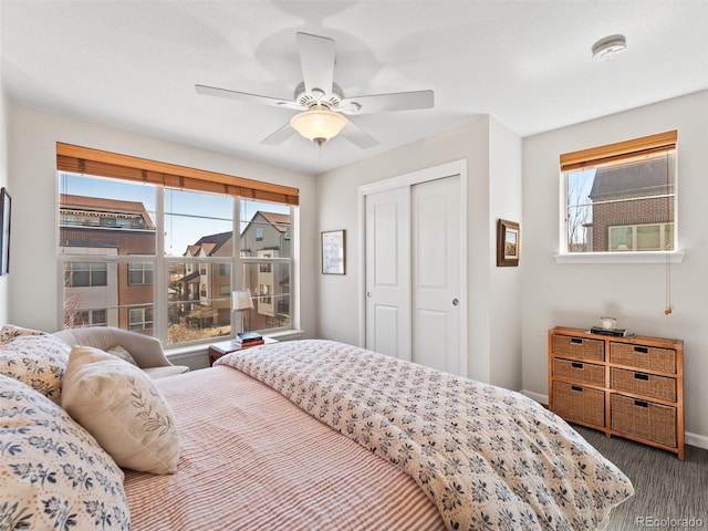 bedroom with a ceiling fan, a closet, and baseboards