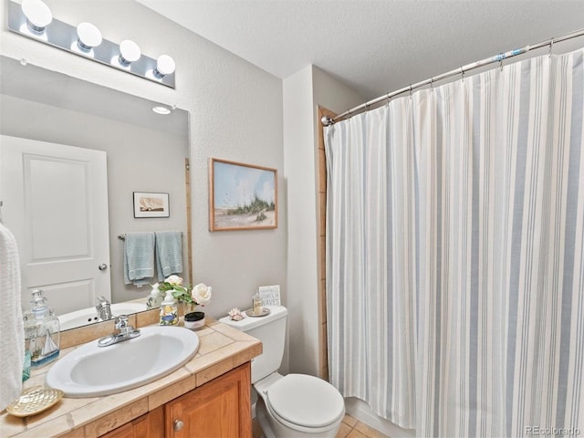 bathroom with a shower with shower curtain, toilet, tile patterned flooring, a textured ceiling, and vanity