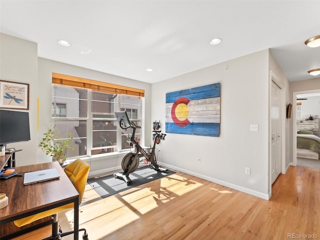 exercise room with recessed lighting, baseboards, and wood finished floors