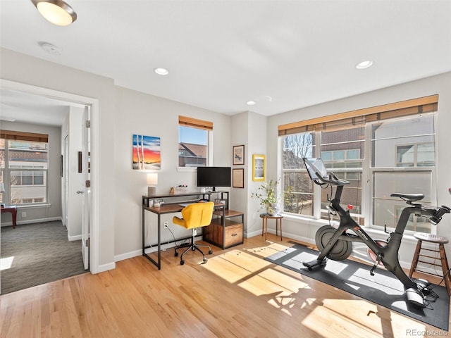 workout room featuring recessed lighting, baseboards, and wood finished floors