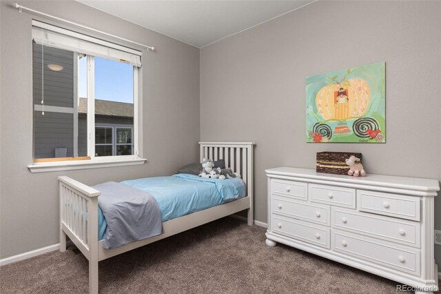 bedroom featuring dark colored carpet