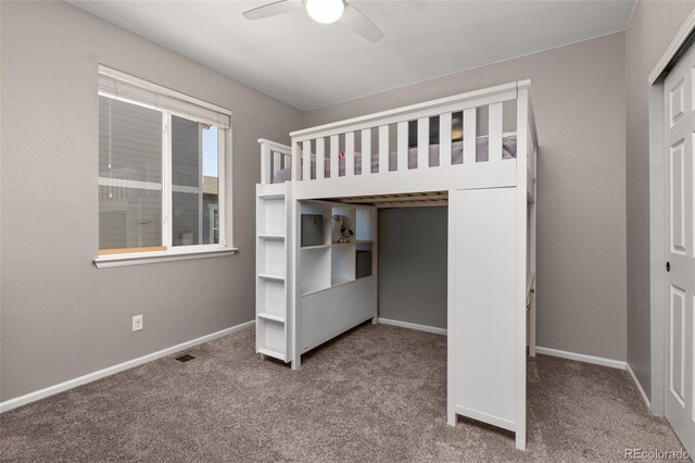 unfurnished bedroom with ceiling fan, a closet, and carpet floors