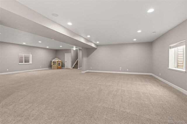 basement featuring light carpet