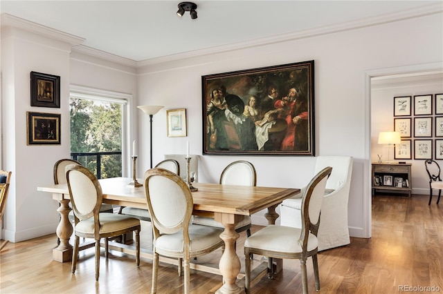 1133 Race St Unit 5A, Denver, CO 80206 - dining area featuring baseboards, crown molding, and wood finished floors
