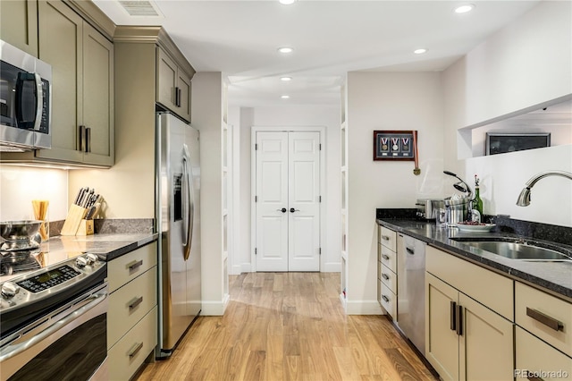 1133 Race St Unit 5A, Denver, CO 80206 - kitchen with recessed lighting, light wood finished floors, a sink, dark stone countertops, and stainless steel appliances