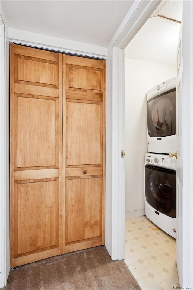 clothes washing area featuring stacked washer / drying machine