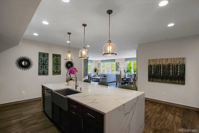 kitchen featuring dishwasher, dark wood-style flooring, open floor plan, and a sink