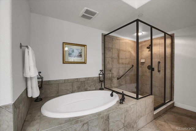 full bath with a bath, visible vents, and a shower stall