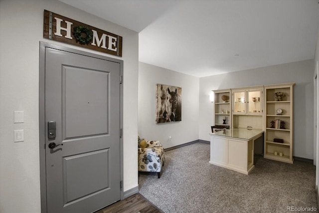 entryway with carpet flooring and baseboards