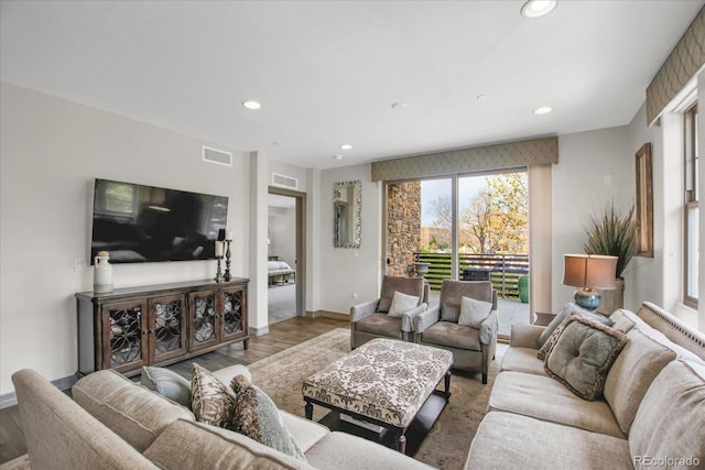 living room with visible vents, wood finished floors, baseboards, and recessed lighting