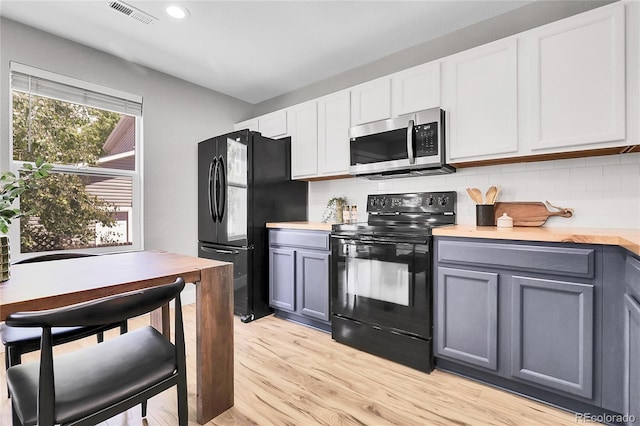 11757 W Tufts Pl, Morrison, CO 80465 - kitchen featuring black appliances, gray cabinetry, light countertops, light wood-style flooring, and decorative backsplash