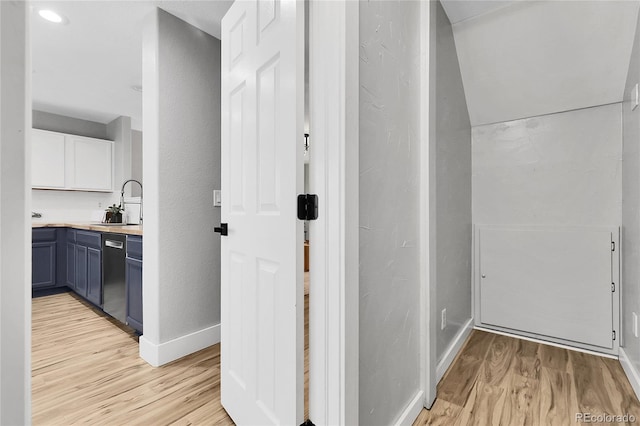11757 W Tufts Pl, Morrison, CO 80465 - corridor with light wood-type flooring, baseboards, a sink, and a textured wall