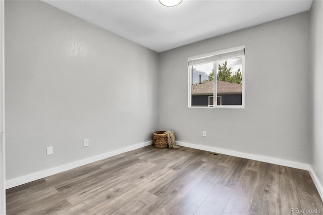 11757 W Tufts Pl, Morrison, CO 80465 - spare room featuring baseboards and wood finished floors