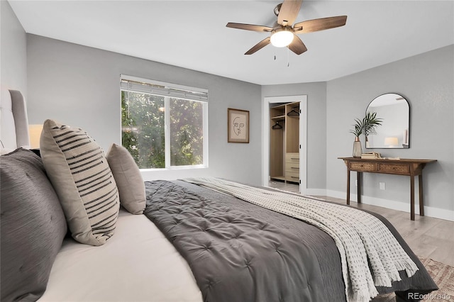 11757 W Tufts Pl, Morrison, CO 80465 - bedroom featuring wood finished floors, a ceiling fan, and baseboards
