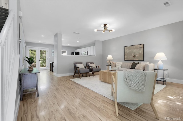 11757 W Tufts Pl, Morrison, CO 80465 - living area featuring baseboards, light wood-style flooring, recessed lighting, a chandelier, and french doors