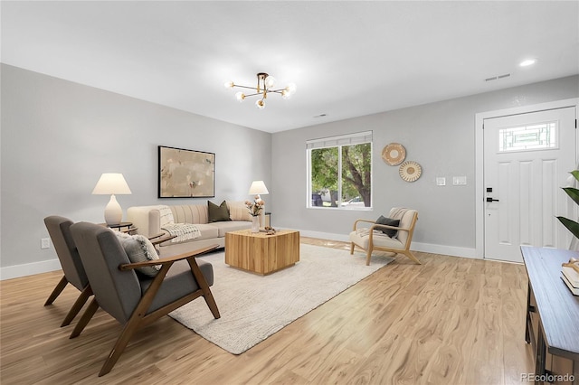 11757 W Tufts Pl, Morrison, CO 80465 - living room featuring baseboards, light wood-type flooring, a chandelier, and recessed lighting