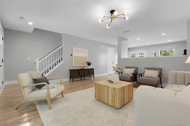 11757 W Tufts Pl, Morrison, CO 80465 - living area with a chandelier, light wood-style floors, recessed lighting, stairs, and baseboards