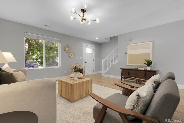 11757 W Tufts Pl, Morrison, CO 80465 - living room with stairway, light wood finished floors, a chandelier, and baseboards