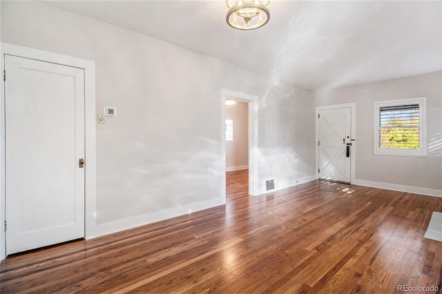 spare room featuring dark hardwood / wood-style flooring